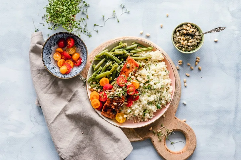 A colourful seasonal plate with roasted vegetables, greens, and grains